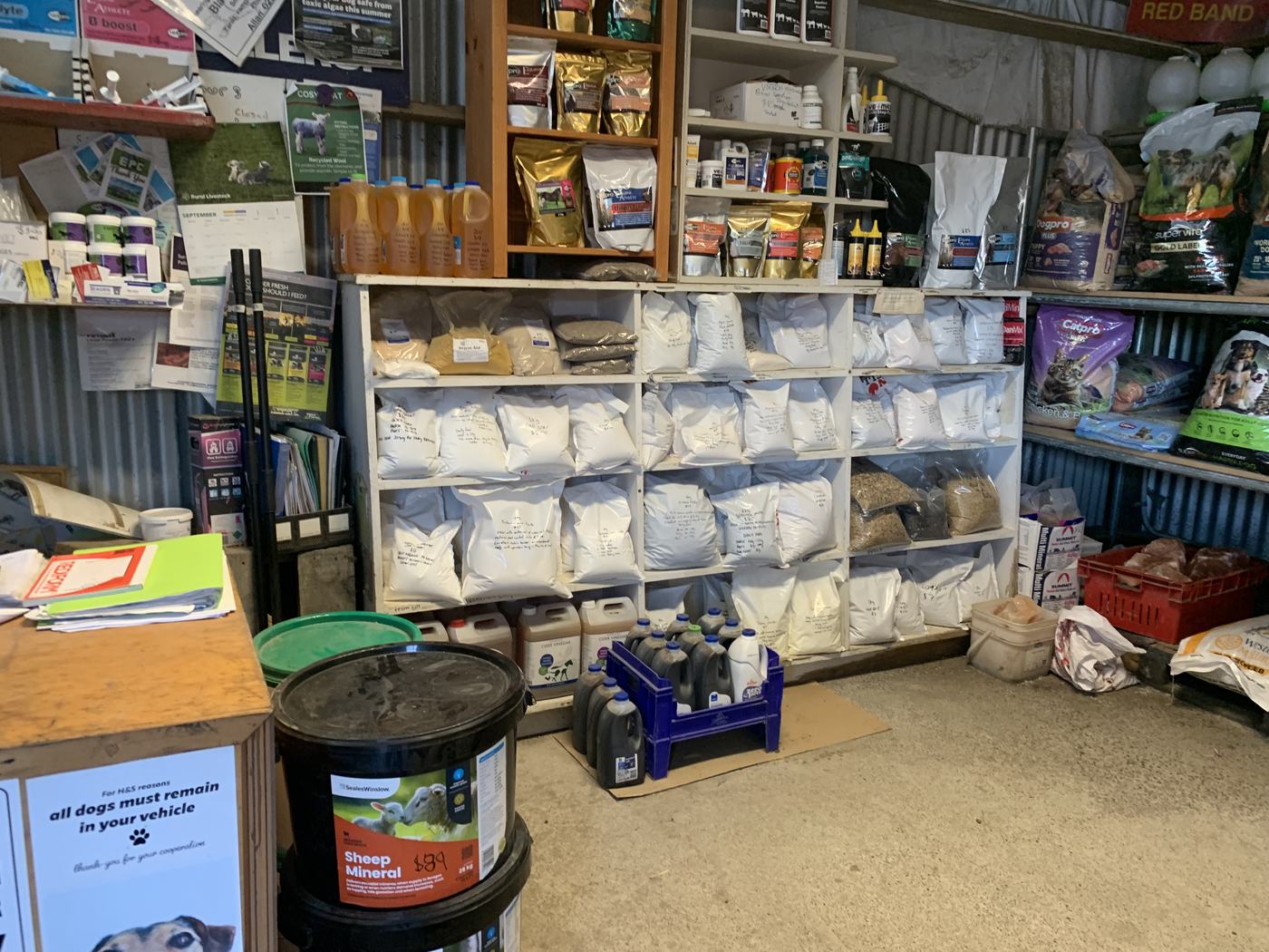 Sheep mineral tub and hand-labelled custom mineral mixes on the shelf